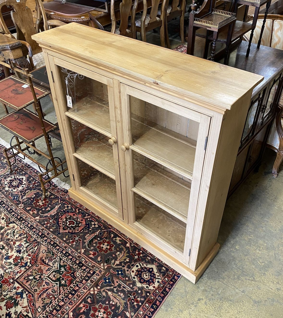 A Victorian and later pine glazed two door bookcase, length 113cm, depth 29cm, height 119cm